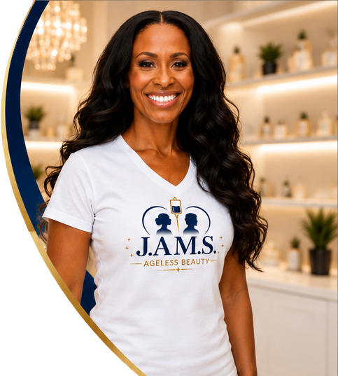 Smiling woman in white JAMS Ageless Beauty T-shirt standing in a bright, modern salon