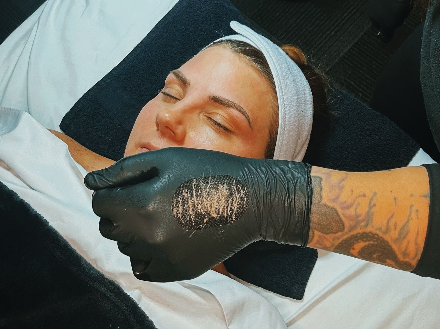 A woman is getting her legs waxed in a beauty salon.