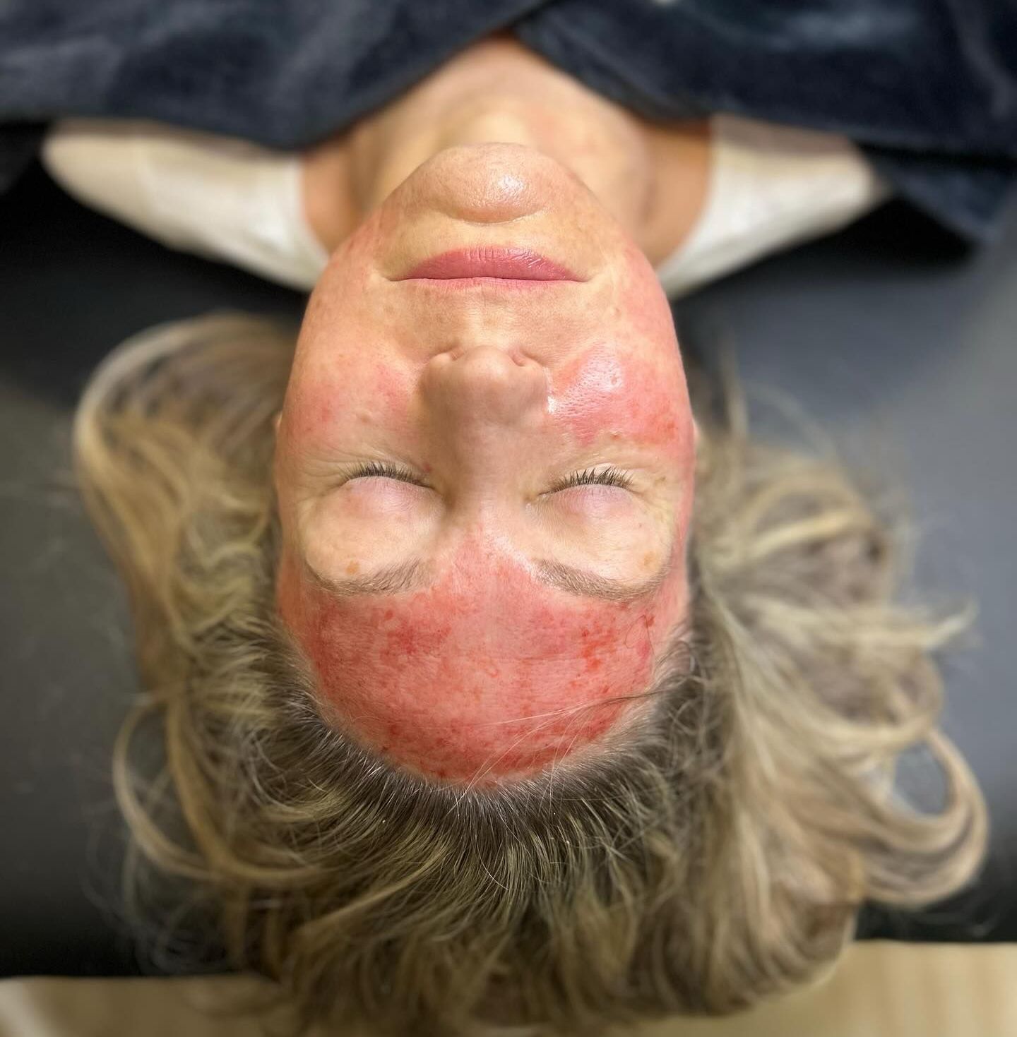 A woman is getting her eyebrows waxed in a beauty salon.