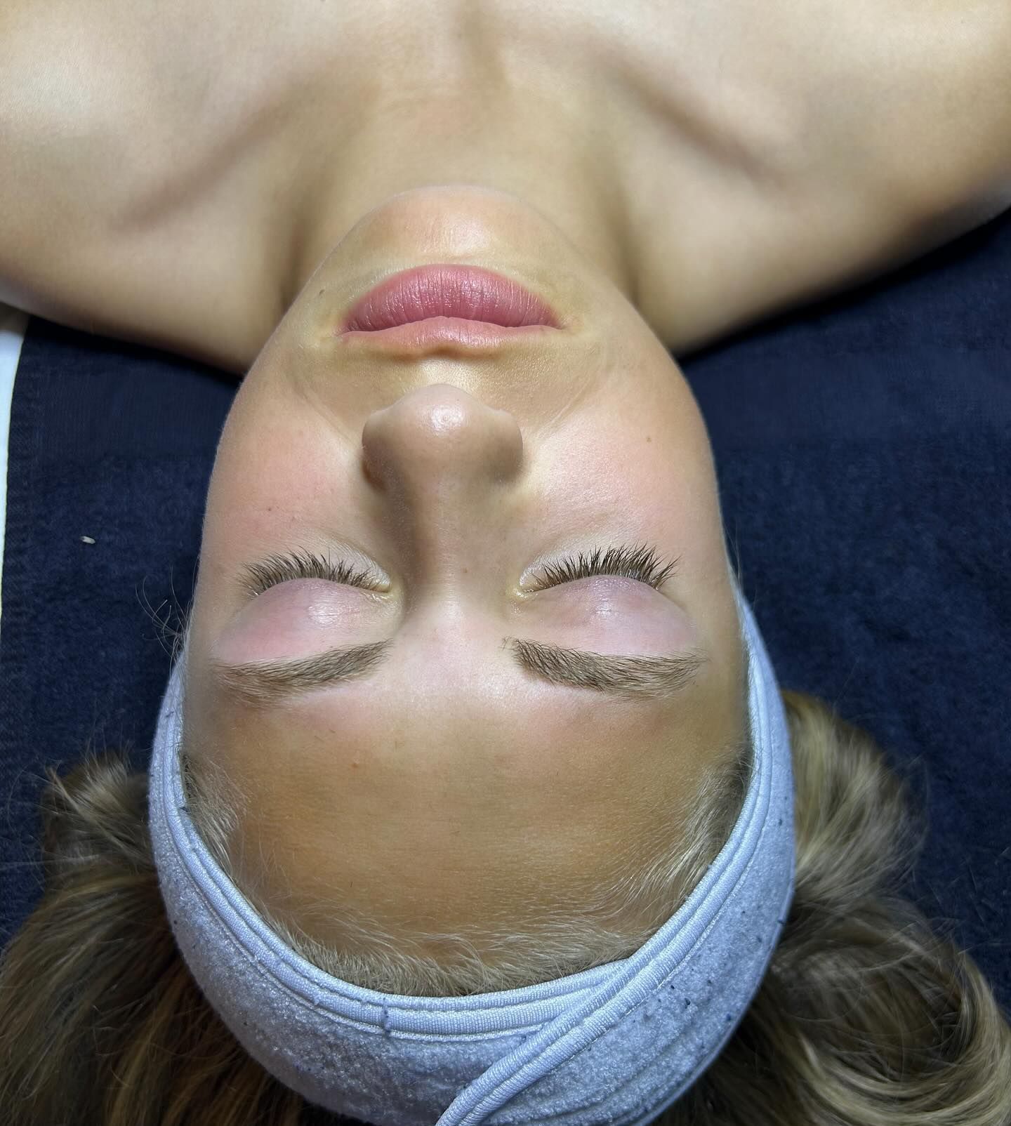 A woman with her eyes closed wearing a headband