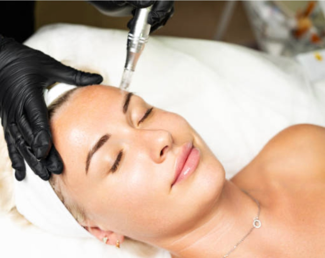 A woman is getting a facial treatment at a beauty salon.