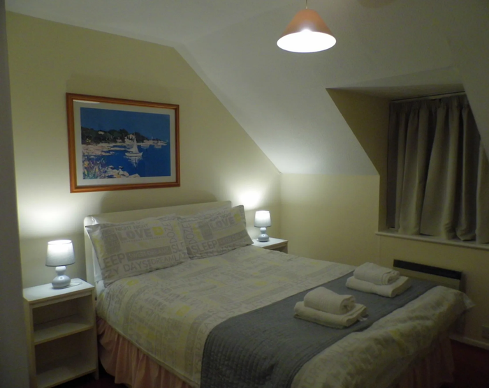 Night time  double bedroom with all lights on.