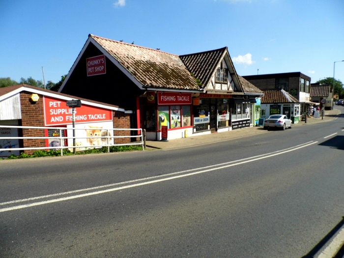 Shops, cafes and restaurants on Wroxham High St. Norfolk.