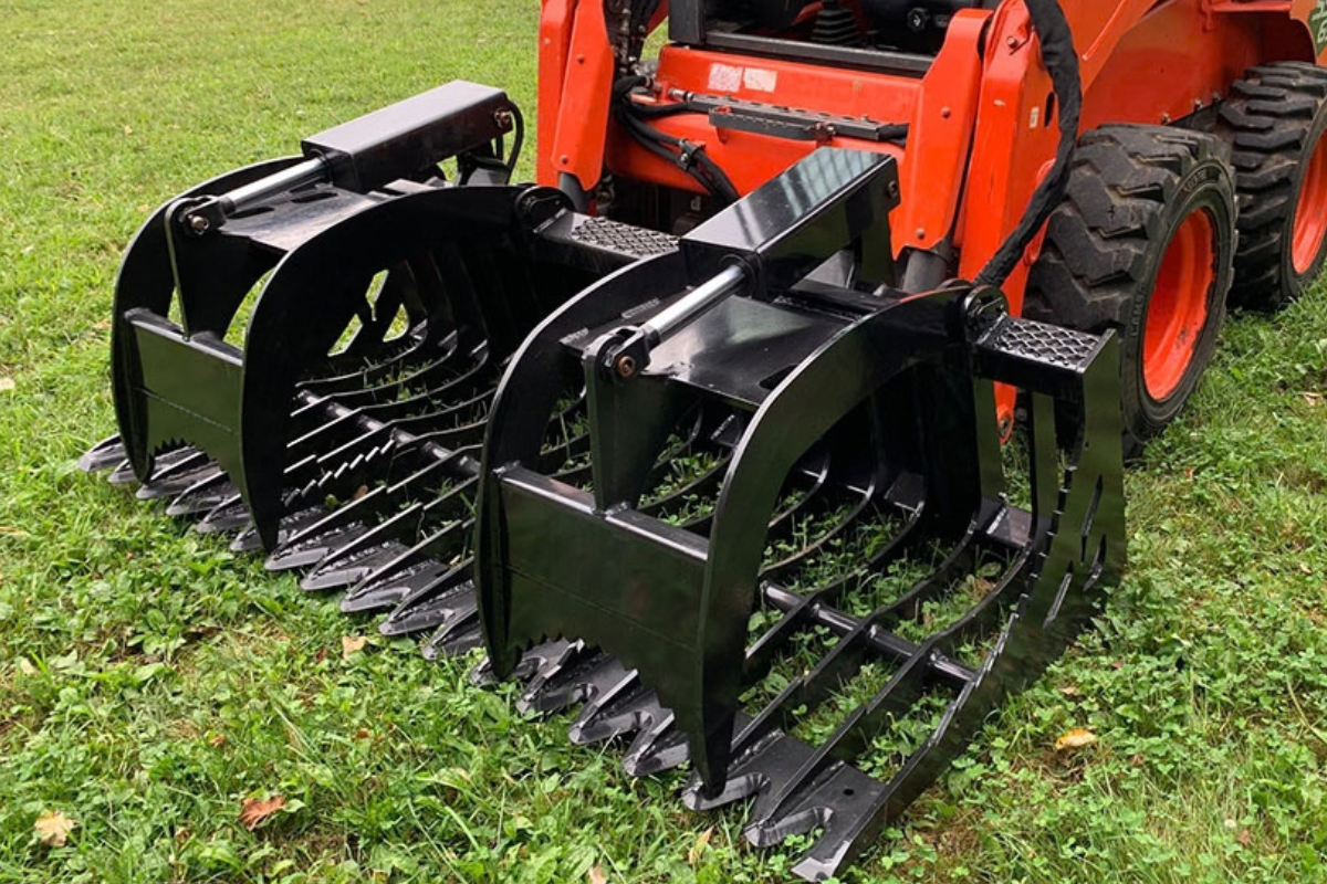 Custom skid loader fork grapple attachment manufactured by Stoltzfus Manufacturing in Lancaster County, PA.