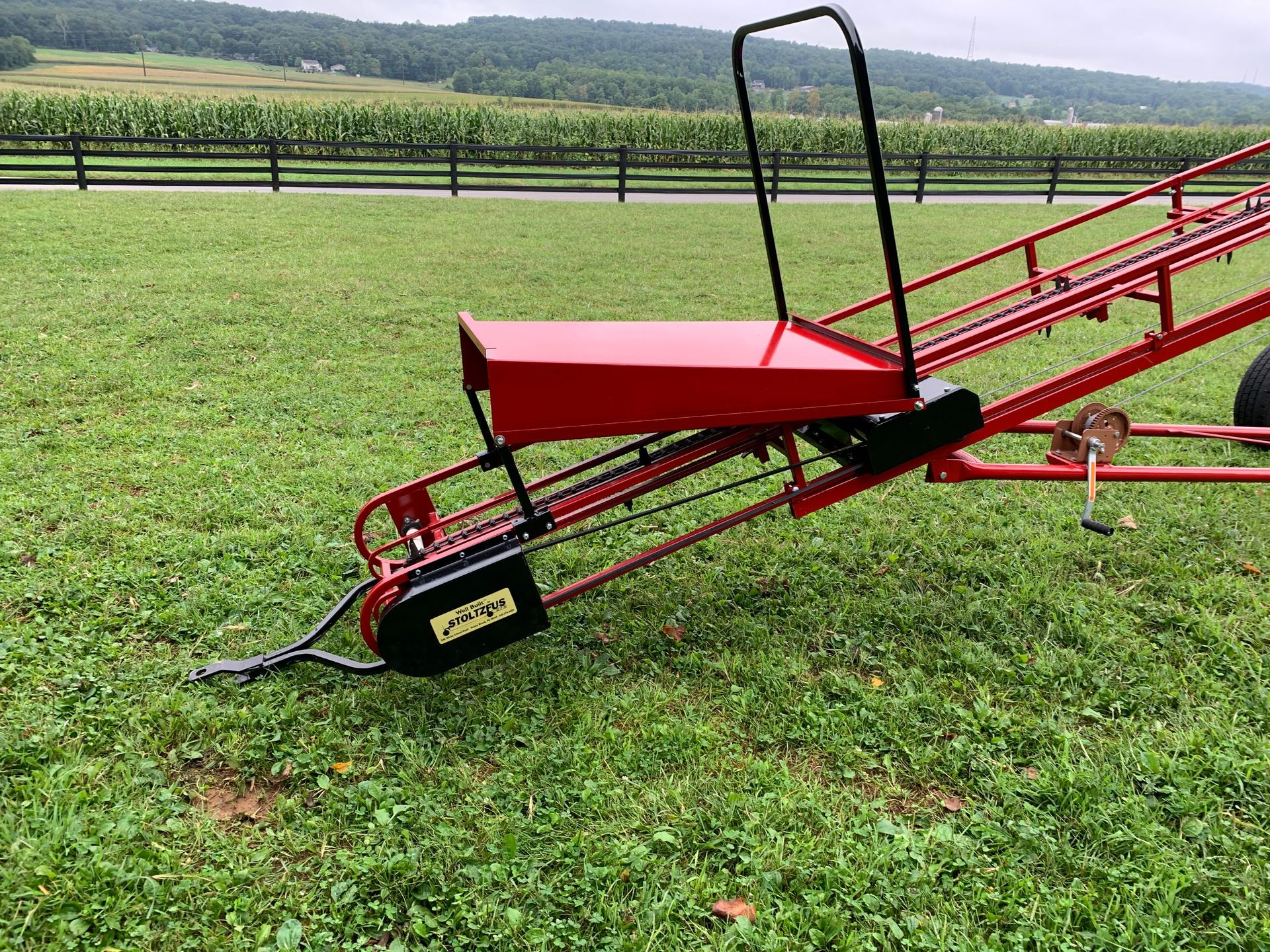 Red hay bale elevator by Stoltzfus Manufacturing for moving hay bales to upper barn levels in Lancaster County, PA.