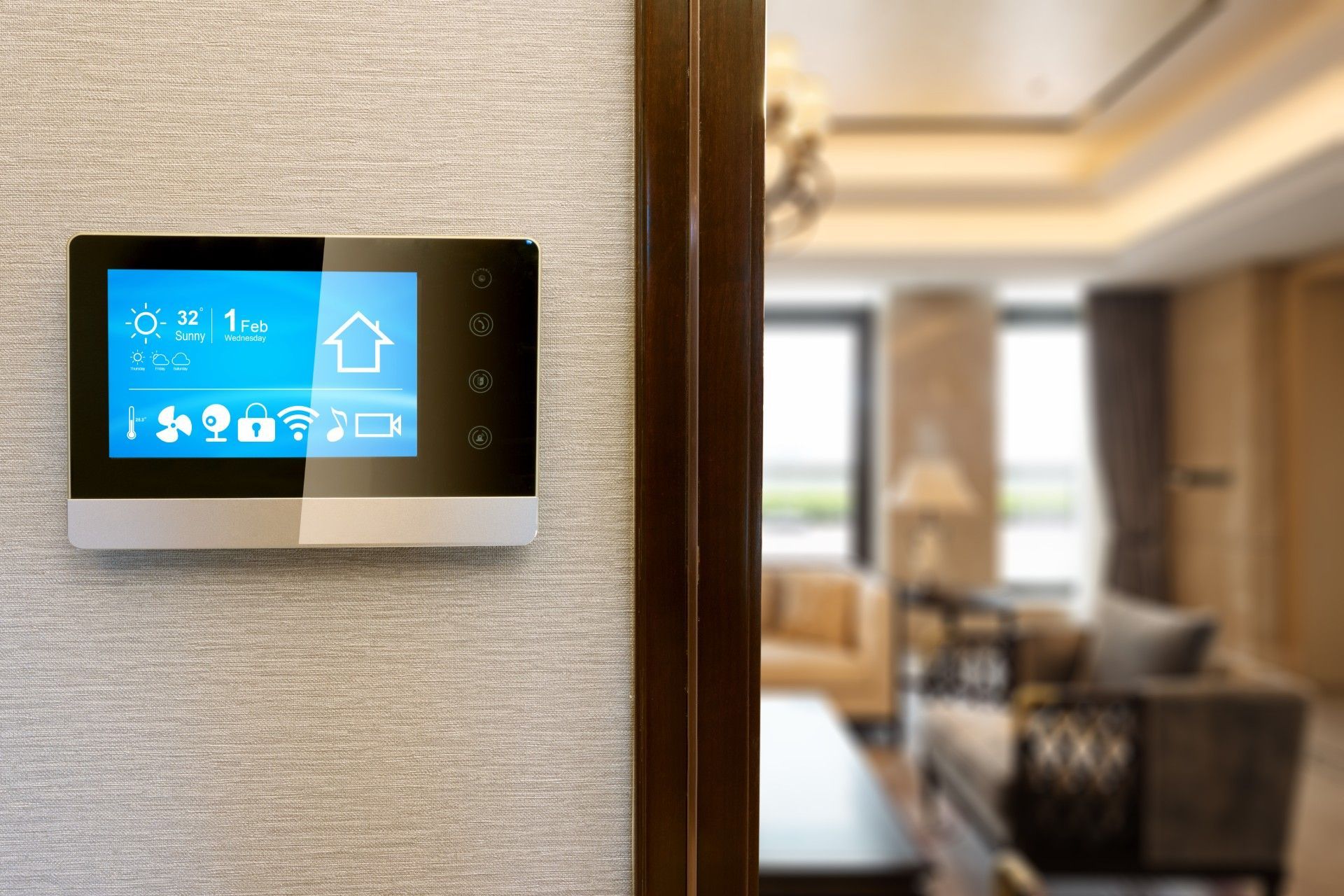 A smart thermostat is hanging on a wall in a living room.