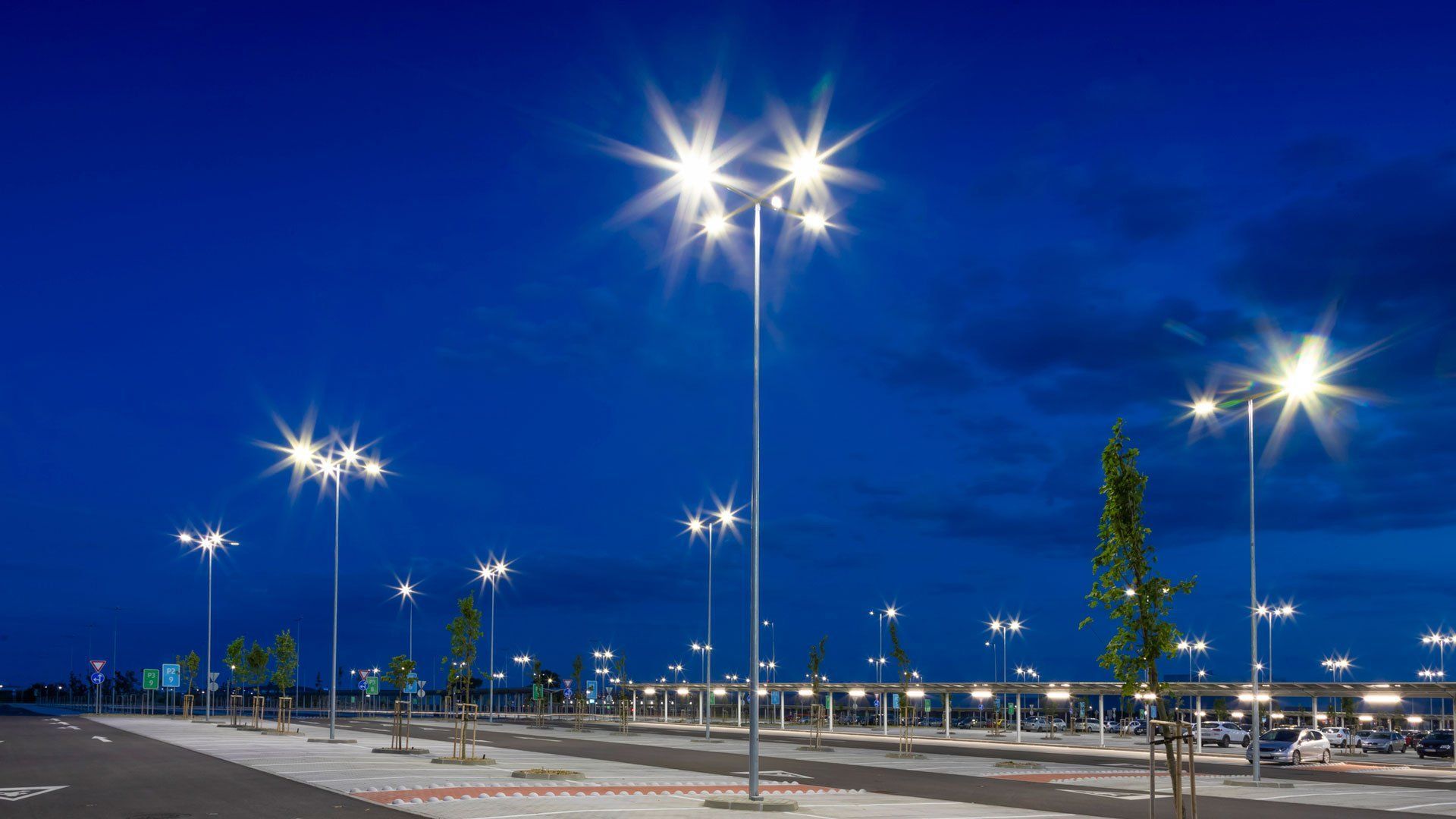 A parking lot filled with lots of lights at night.