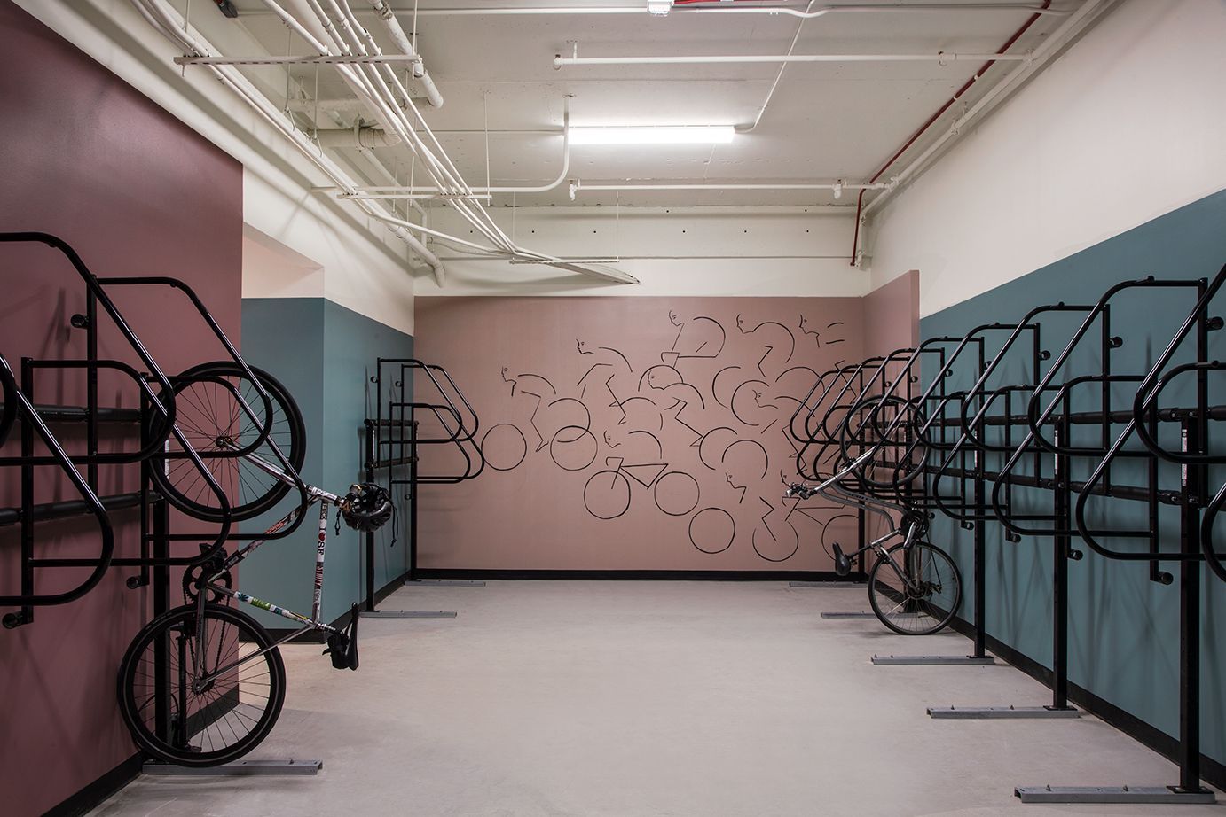 Empty gallery room with metal sculpture displays and abstract wall art