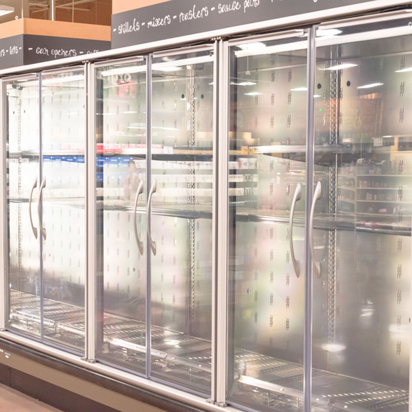 A refrigerator with sliding glass doors in a store