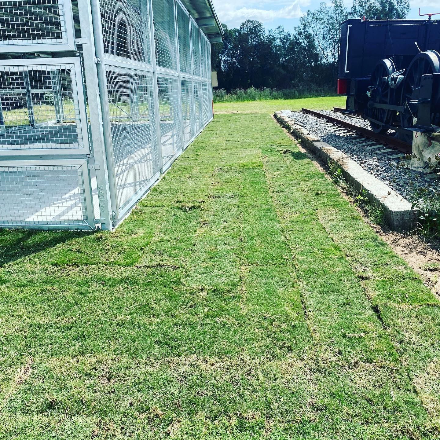 A Fenced Structure Stands Beside a Patch of Green Grass — Edmonds Turf in Nelson Bay, NSW
