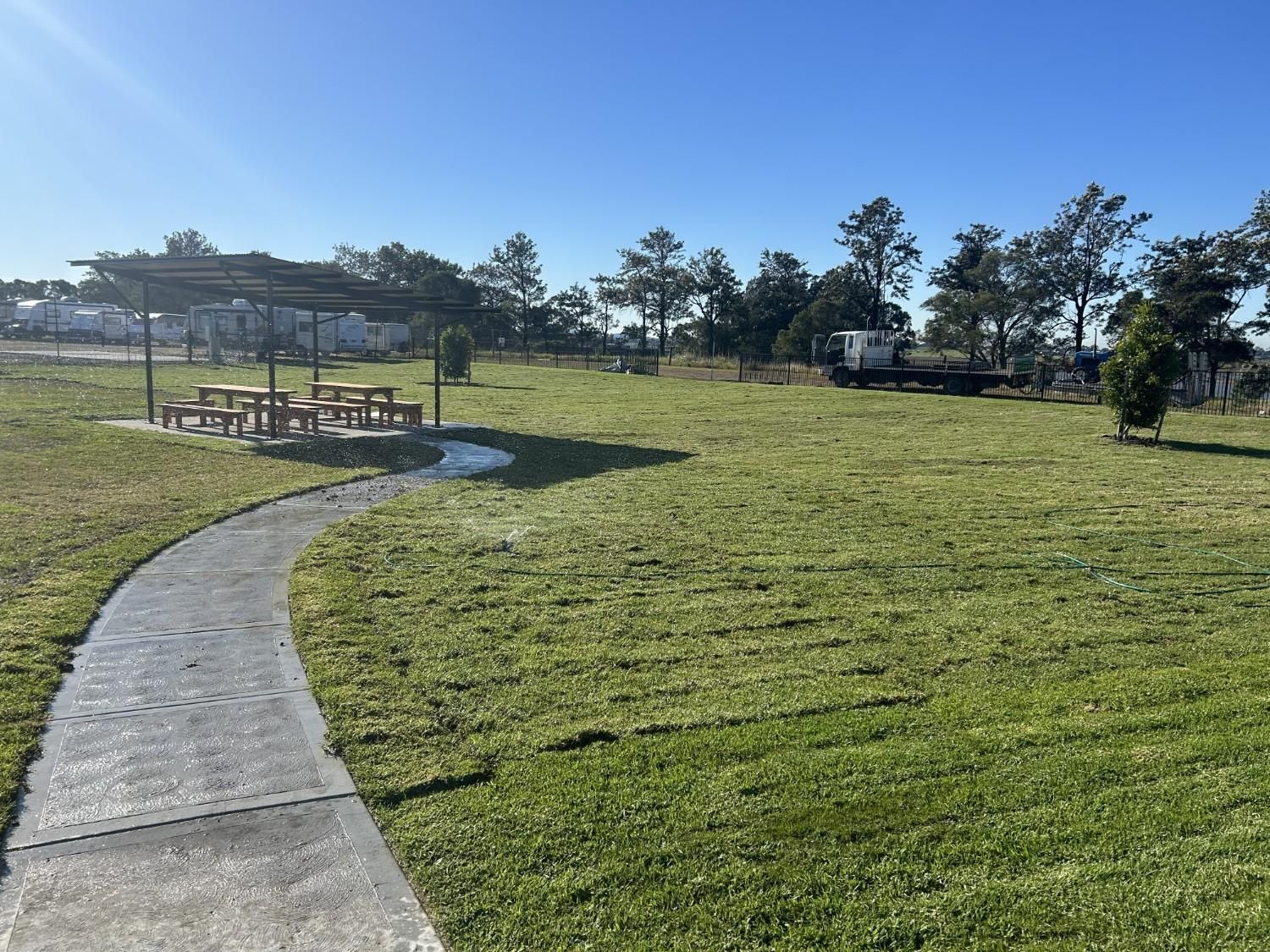 Curved Sidewalk Through a Sunny Grassy Park — Edmonds Turf in Louth Park, NSW
