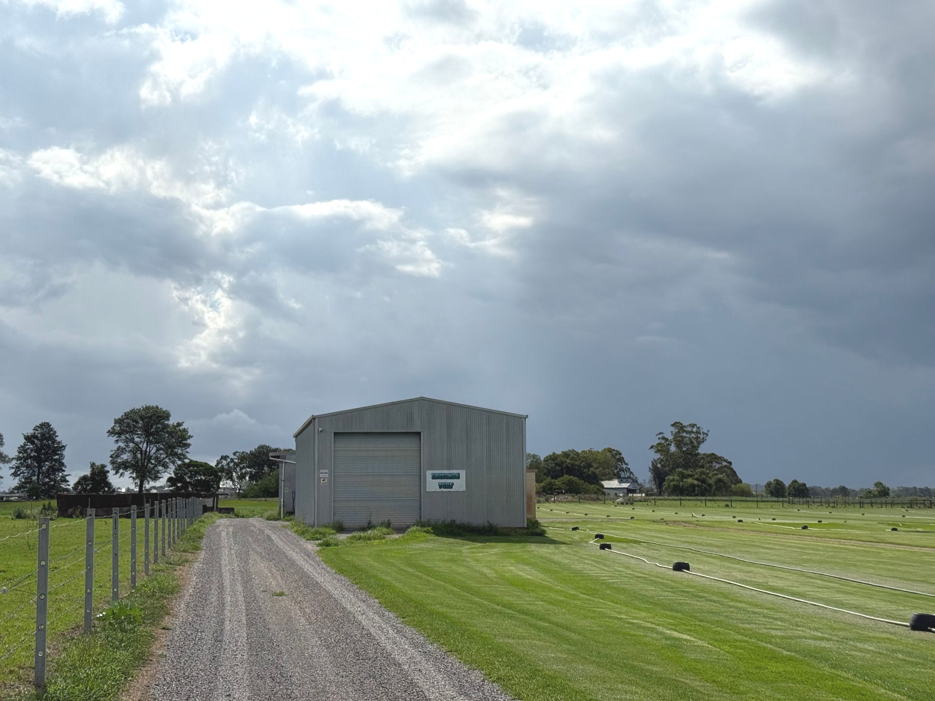 Rural Gravel Drive Leading to a Gray Metal Shed — Edmonds Turf in Lake Macquarie, NSW