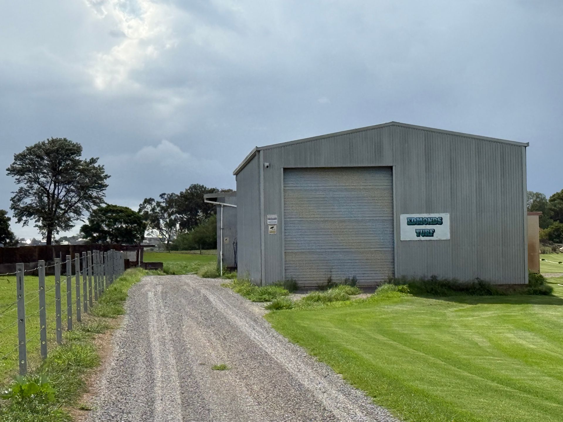 Gravel Driveway Leads to a Gray Metal Warehouse — Edmonds Turf in Port Stephens, NSW