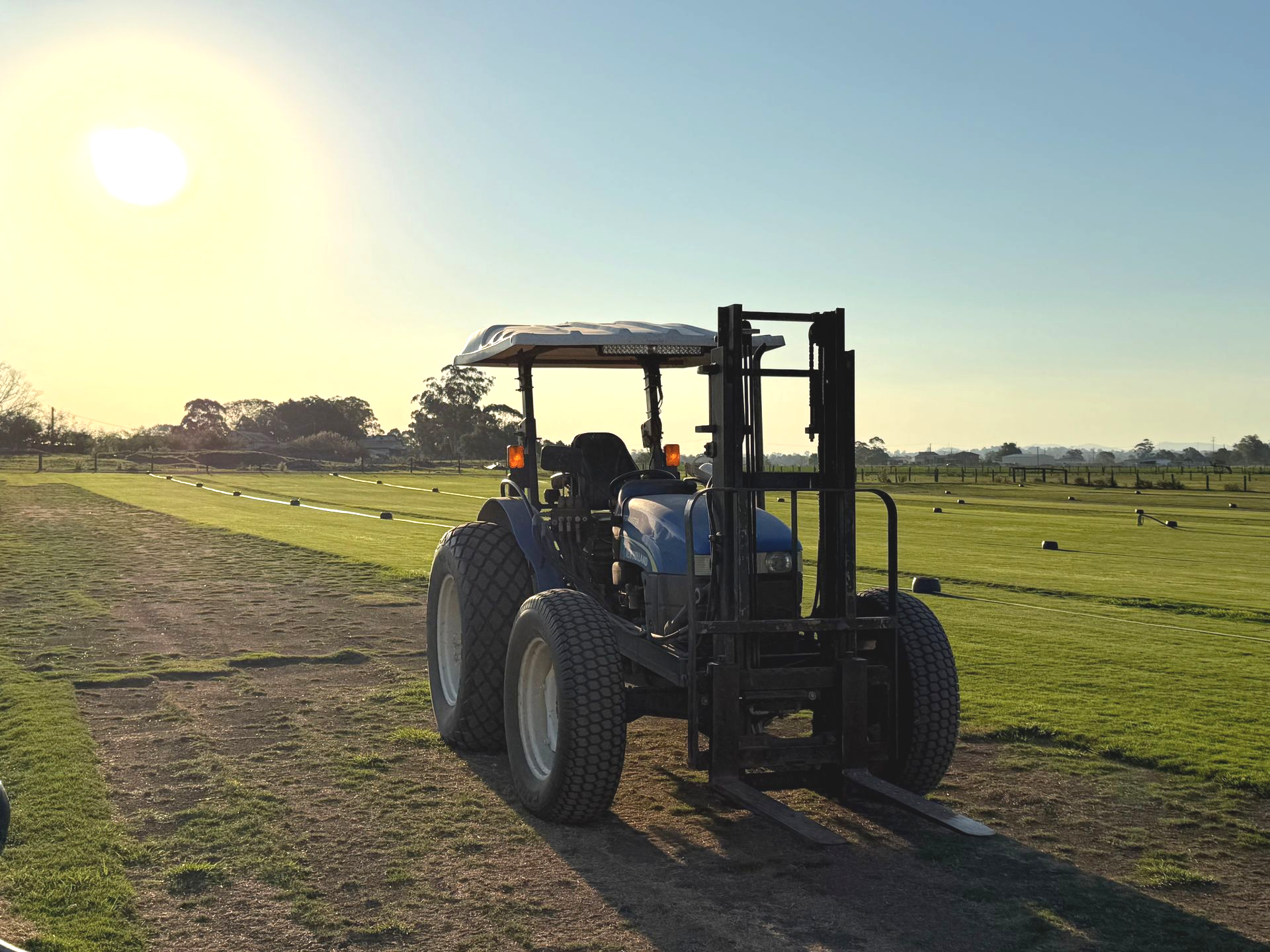 Tractor Driving Across a Grassy Field at Sunset — Edmonds Turf in Hunter Valley, NSW