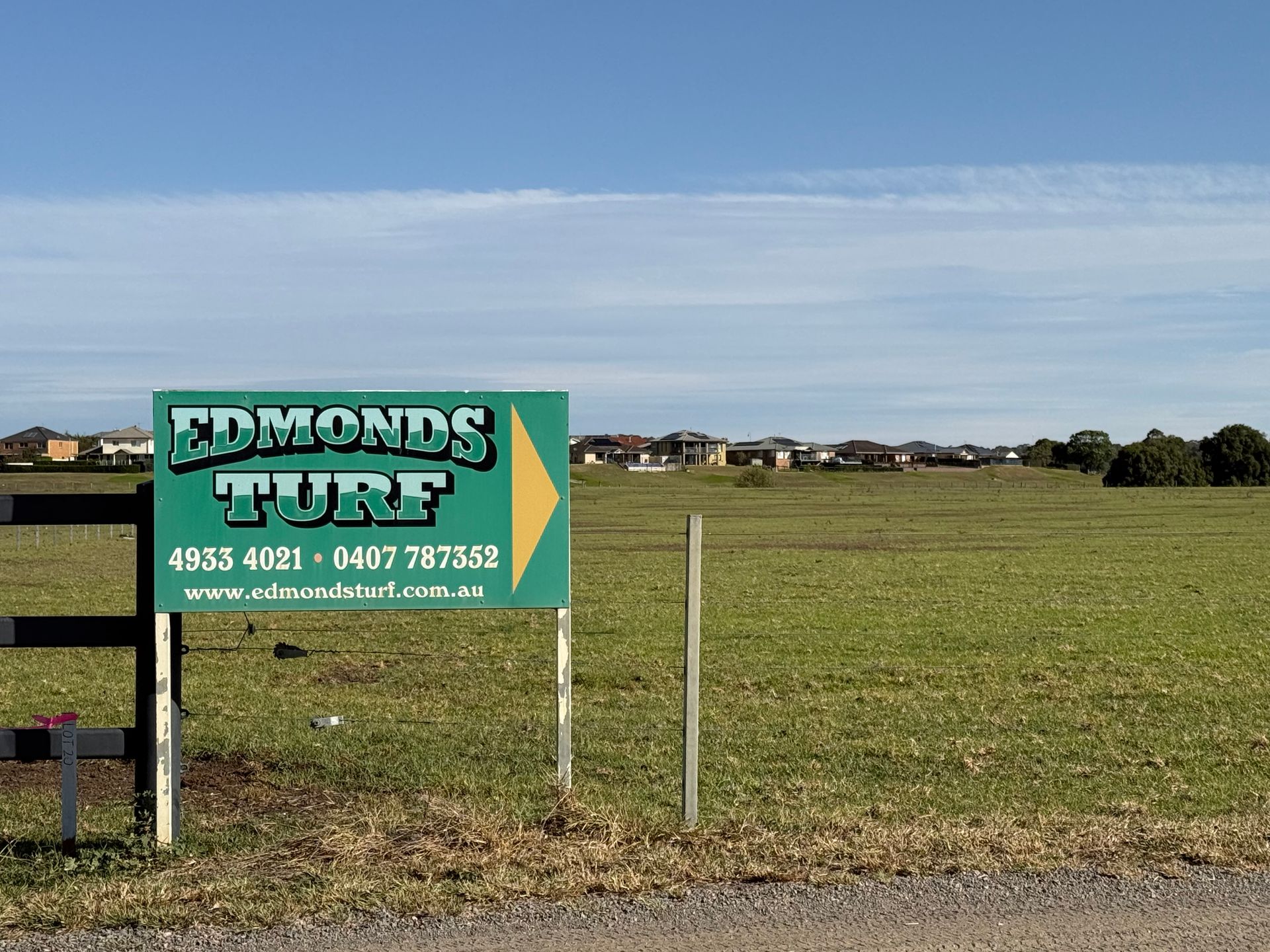 Edmonds Turf Sign Beside a Grassy Open Field Under a Clear Blue Sky — Edmonds Turf in Lochinvar, NSW