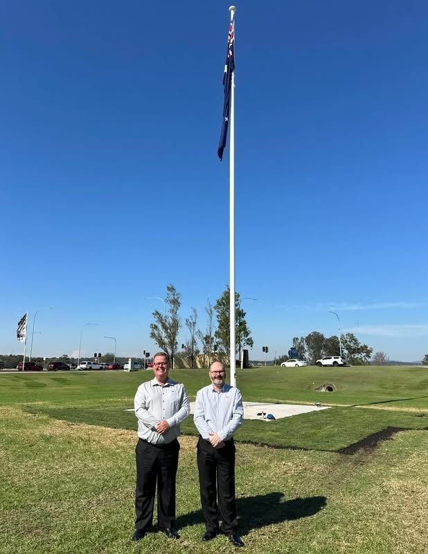 Two People Stand on a Grassy Field — Edmonds Turf in Louth Park, NSW