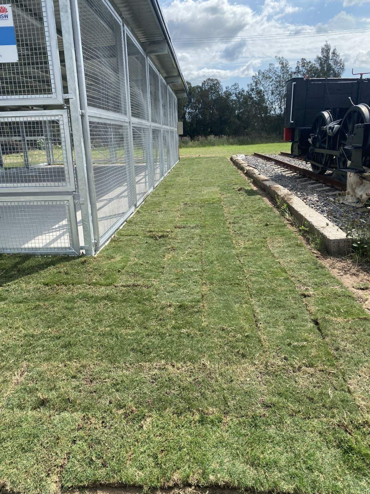 Grassy Path Beside a Chain-link Enclosure — Edmonds Turf in Louth Park, NSW