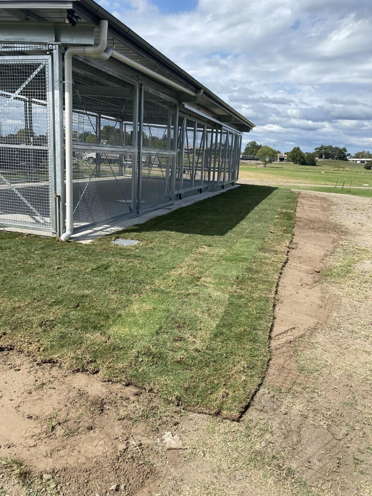 Outdoor Fenced Building Beside Grassy Field — Edmonds Turf in Louth Park, NSW