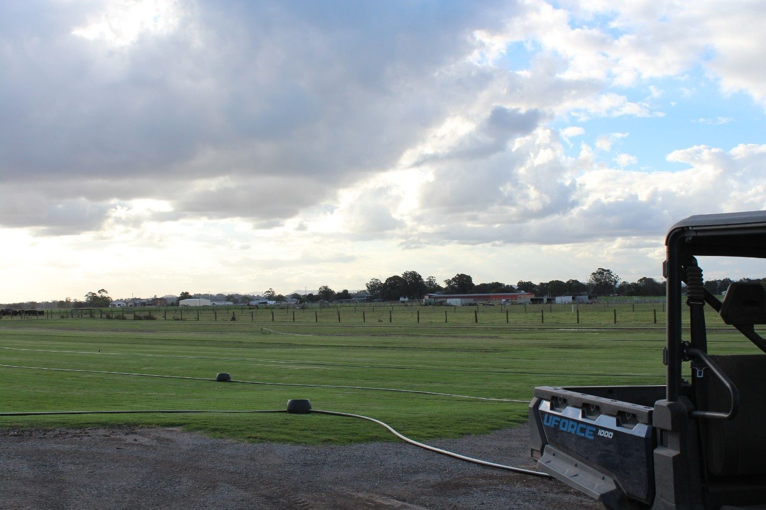 Grassy Field Under Cloudy Sky With a Tractor — Edmonds Turf in Louth Park, NSW