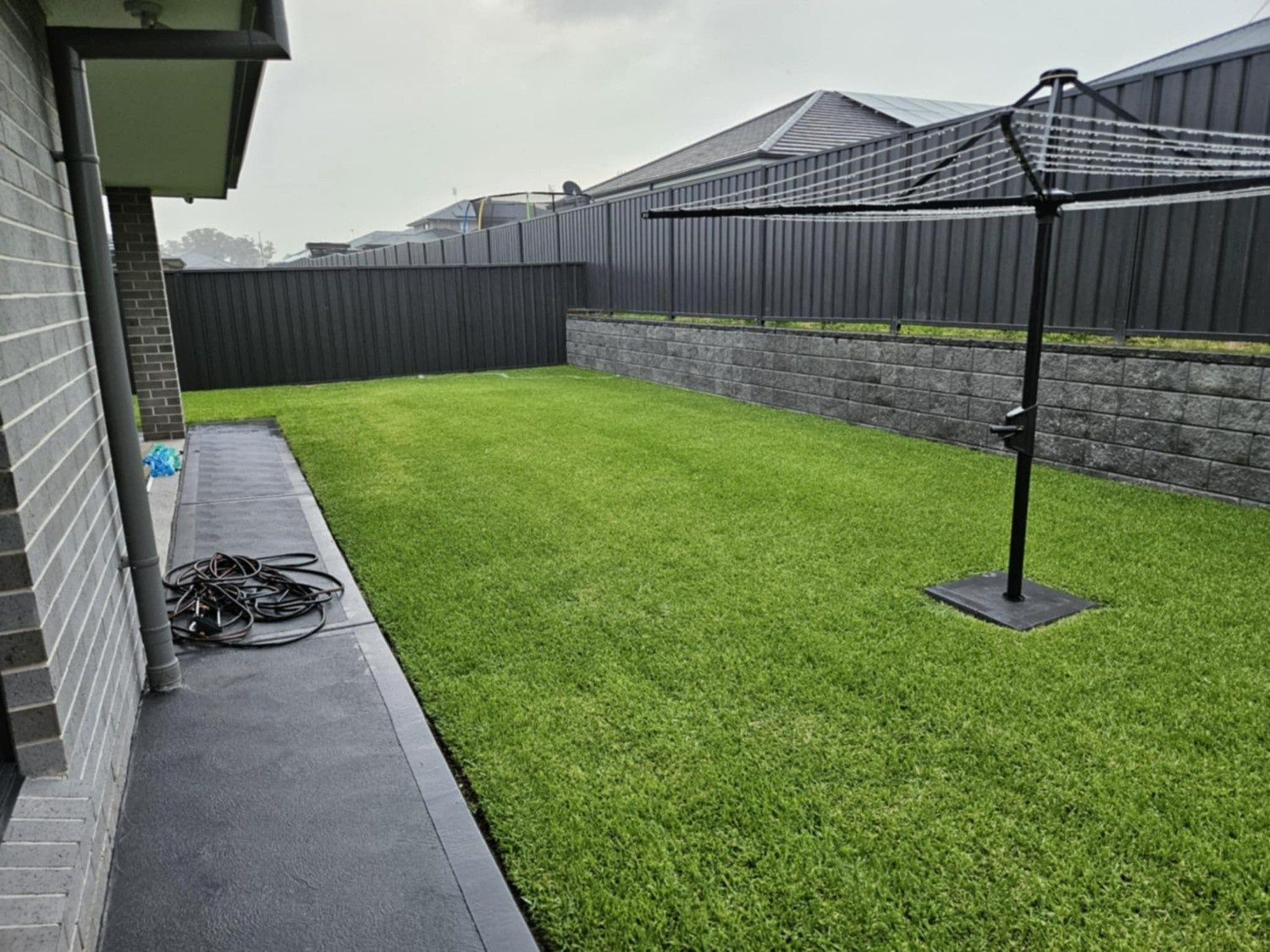Backyard With Green Lawn, Concrete Patio — Edmonds Turf in Louth Park, NSW