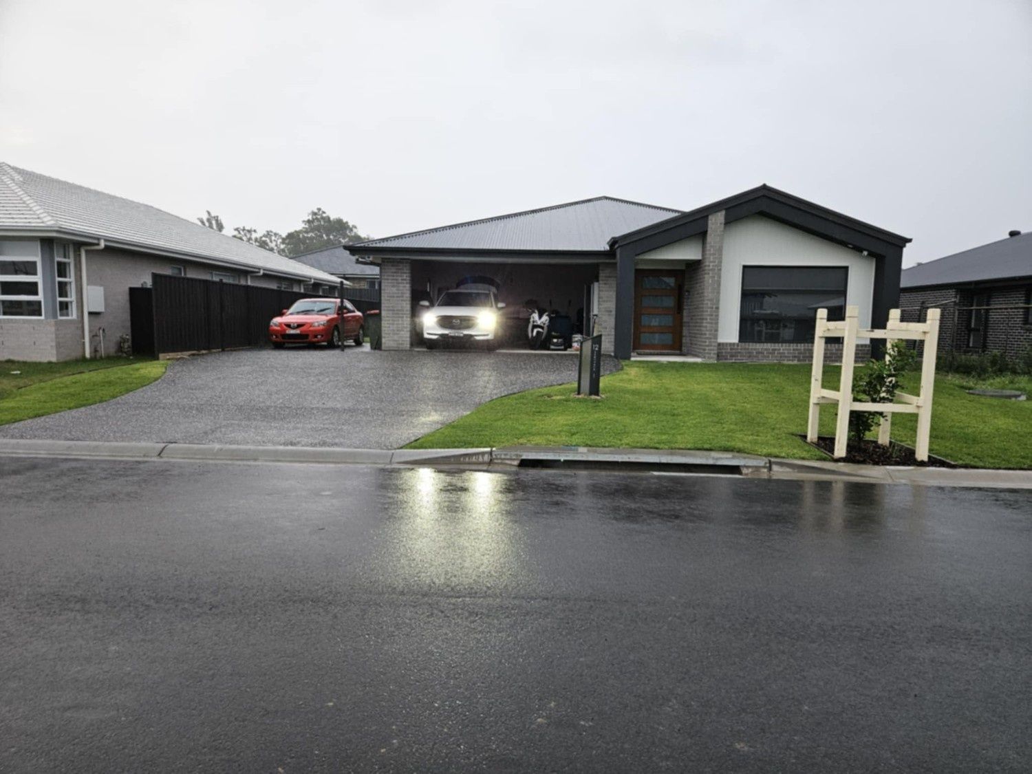 Modern Suburban House With Two Cars in a Driveway — Edmonds Turf in Louth Park, NSW