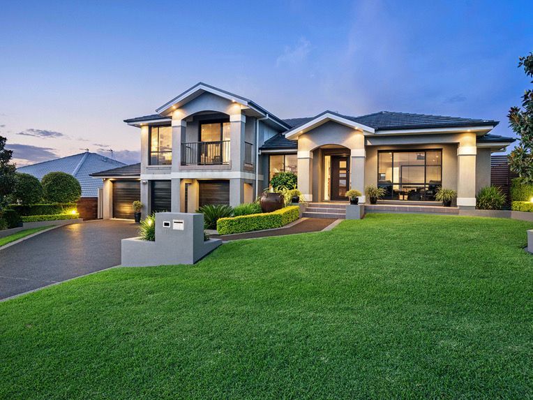 Large modern two-story house with illuminated windows — Edmonds Turf in Louth Park, NSW