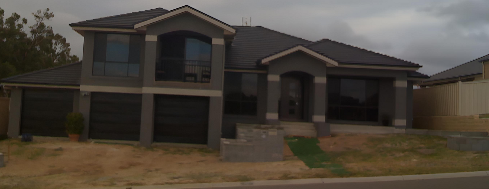 Large Dark-gray Two-story House Under Cloudy Skies — Edmonds Turf in Louth Park, NSW