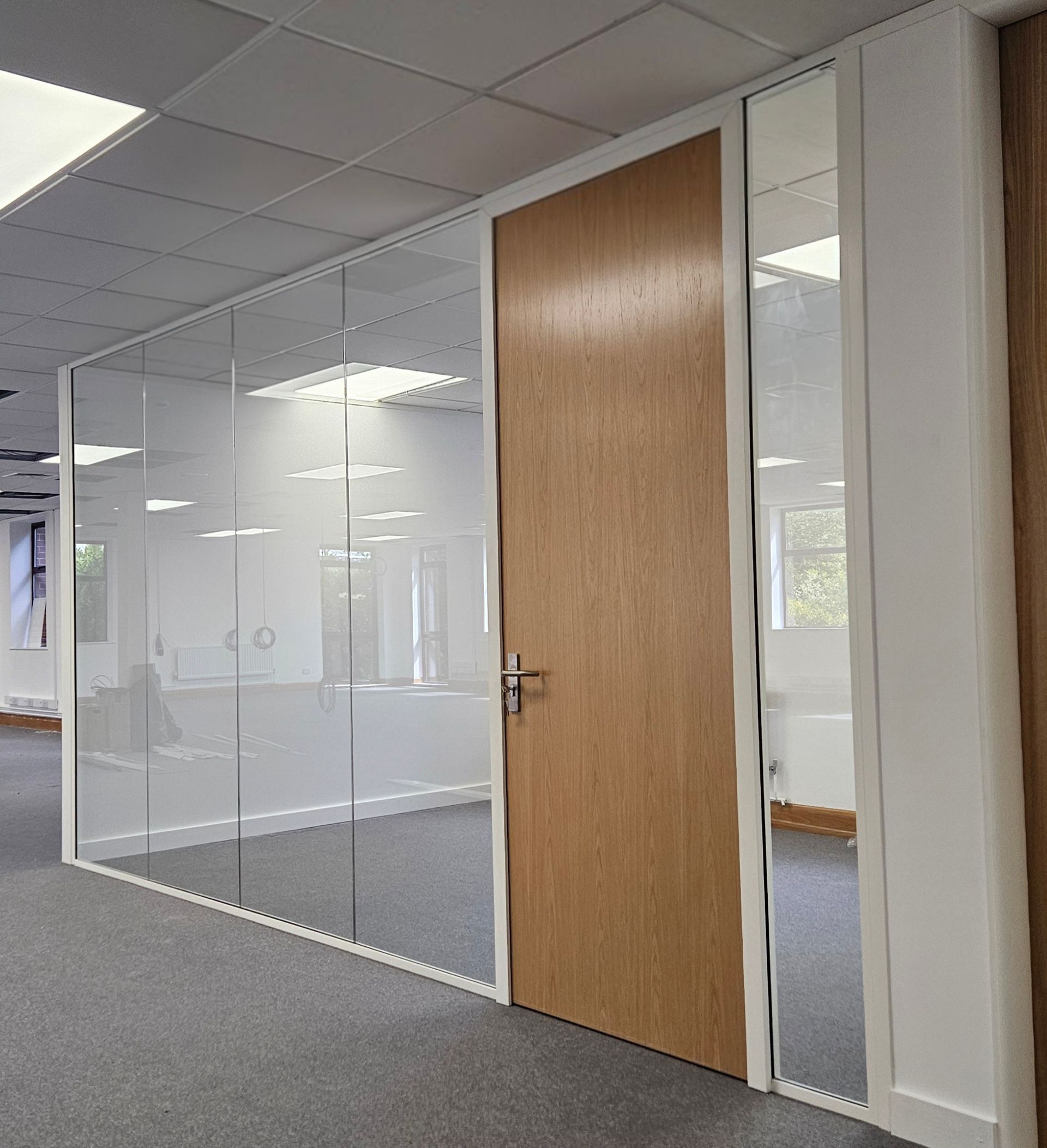 Frameless single glazed office partitions in Sunderland with timber doors