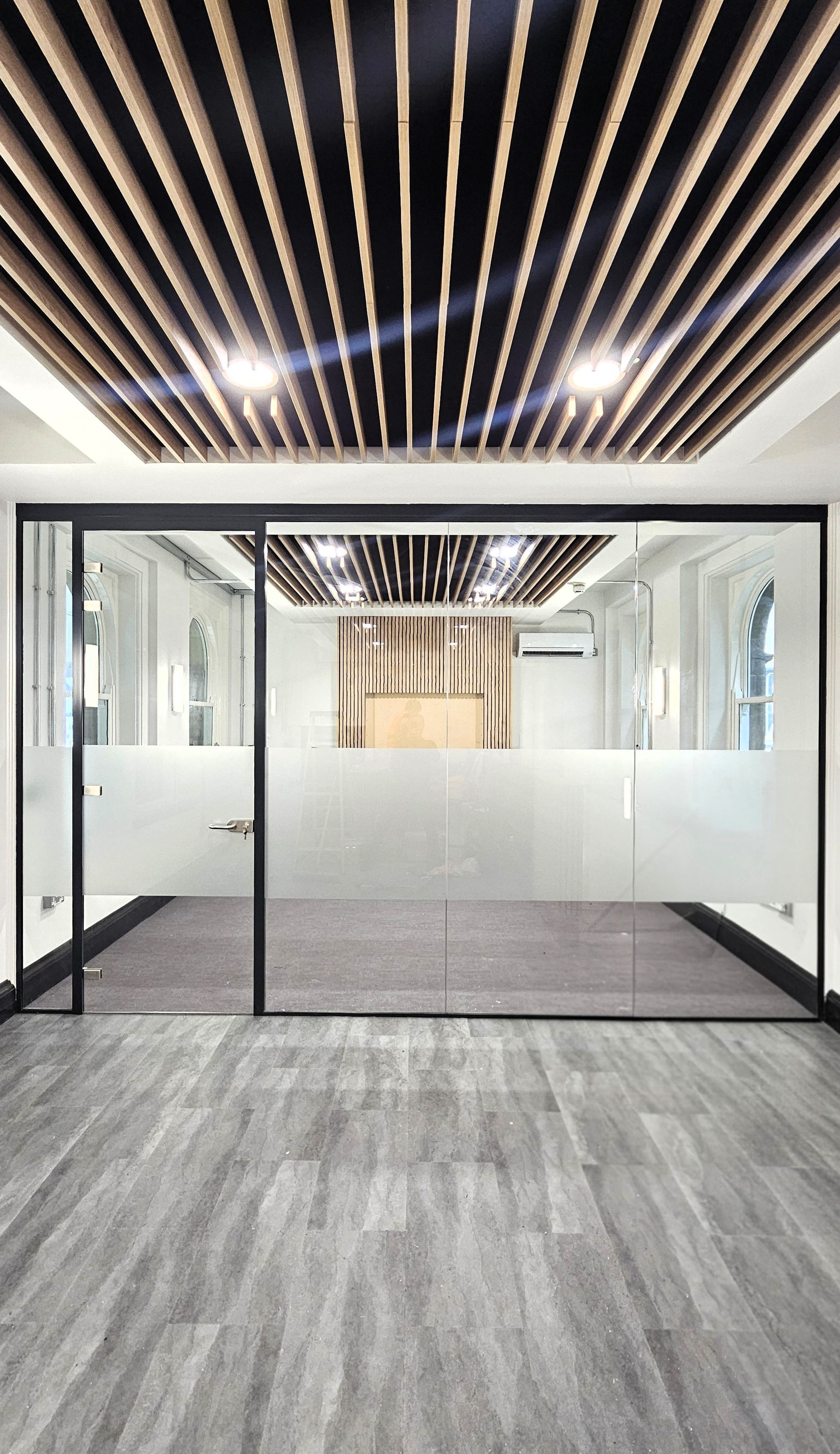 Single glazed office glass partition with door frame and glass door, installed at Newcastle Central Station