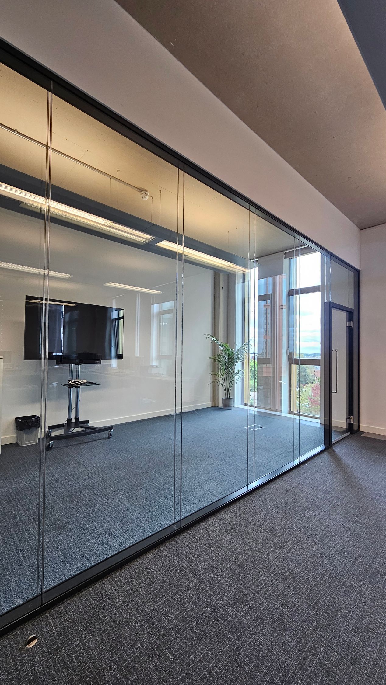 Frameless acoustic glass door with double glazed glass partition system at Newcastle University Office Complex