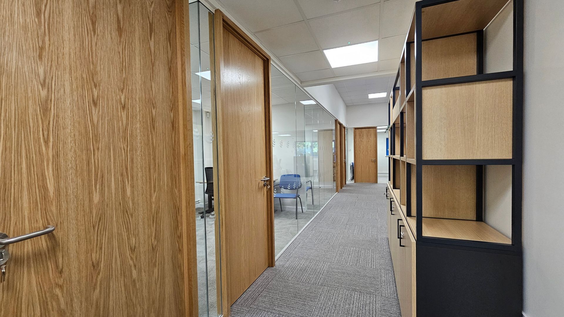 Clear Divide Glass Partitions installation — bespoke single glazed office partitions with timber detailing