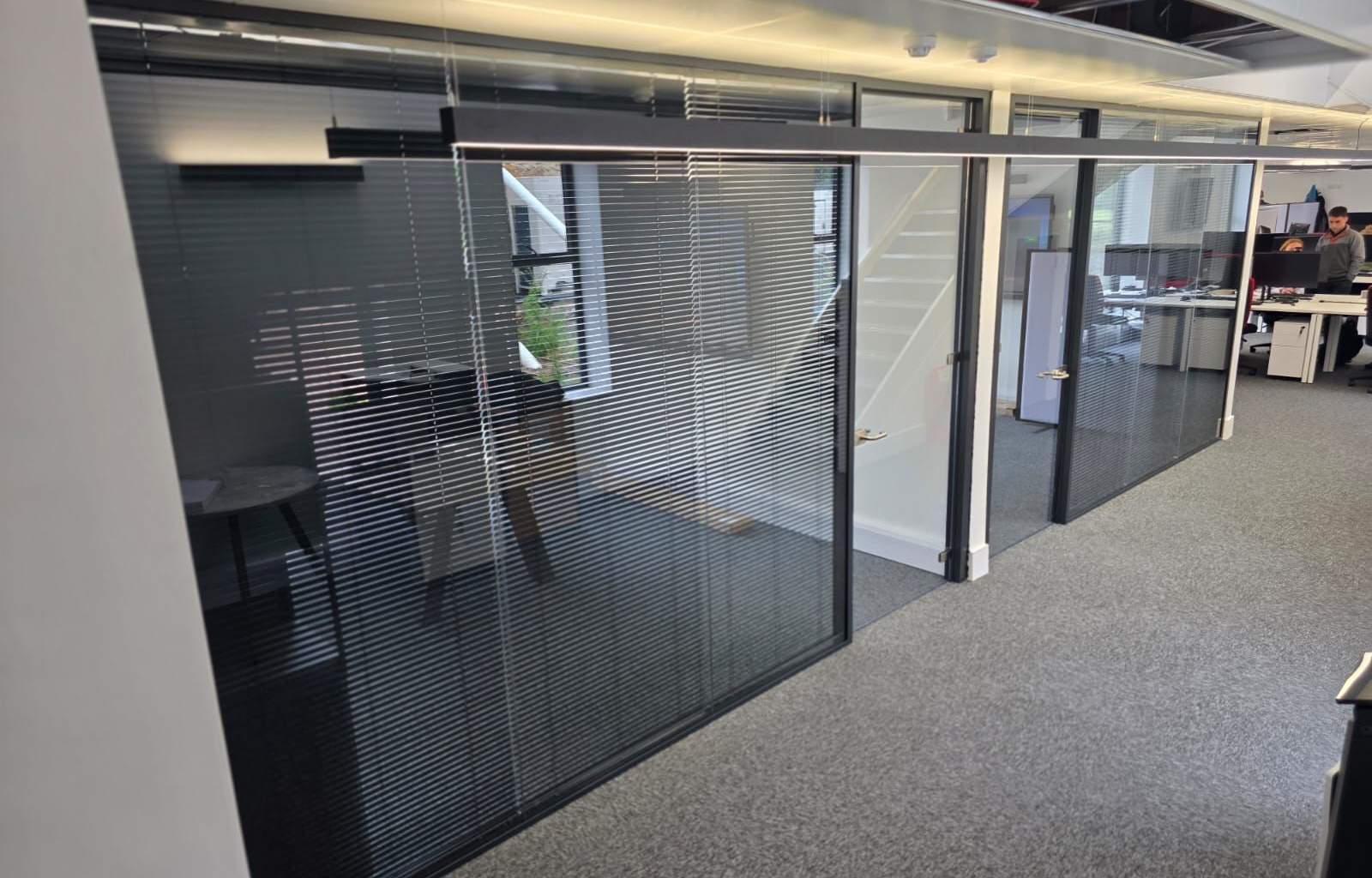 Executive office glass partitions with integral blinds