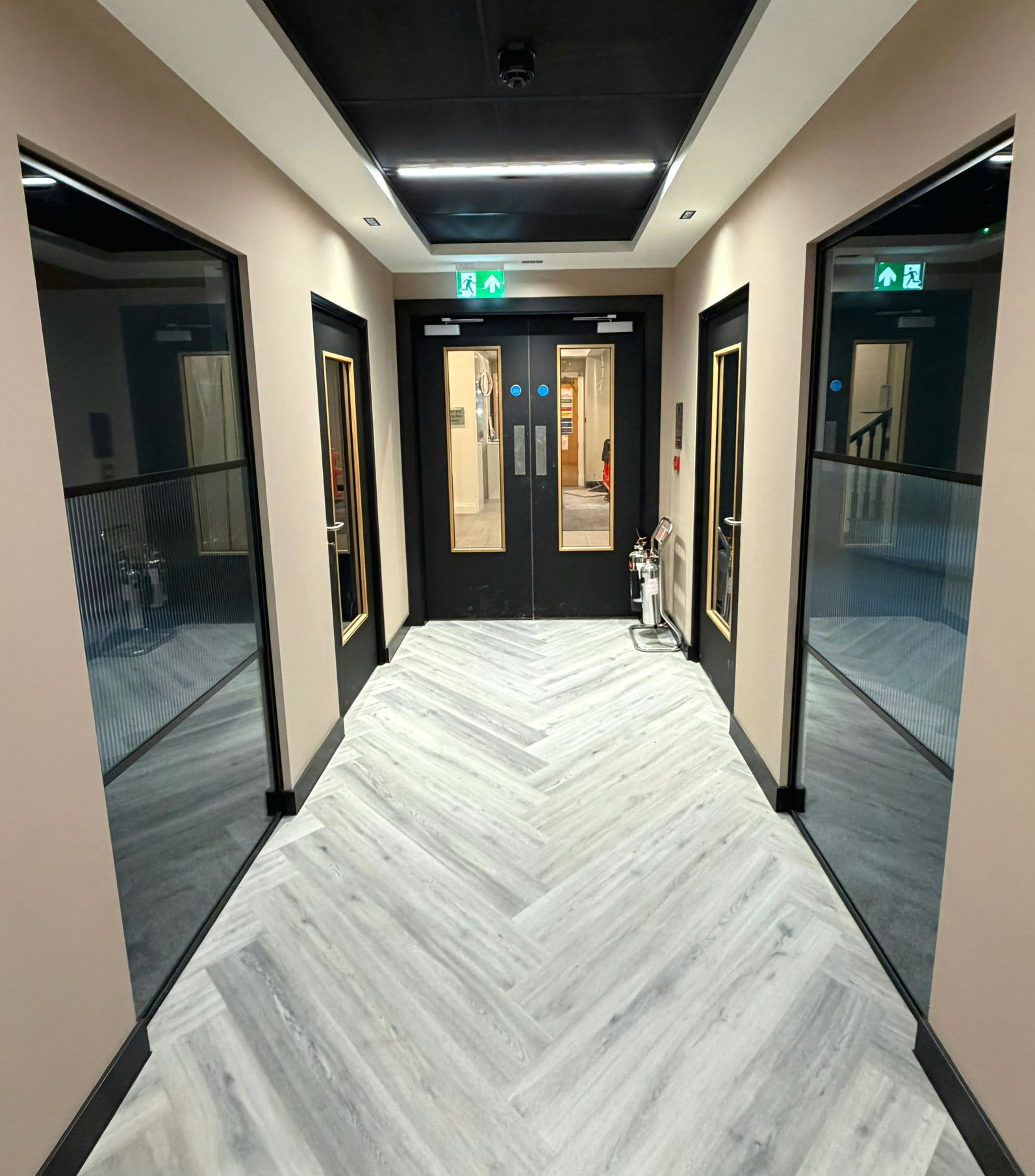 Industrial style meeting room partitions with acoustic glass panels