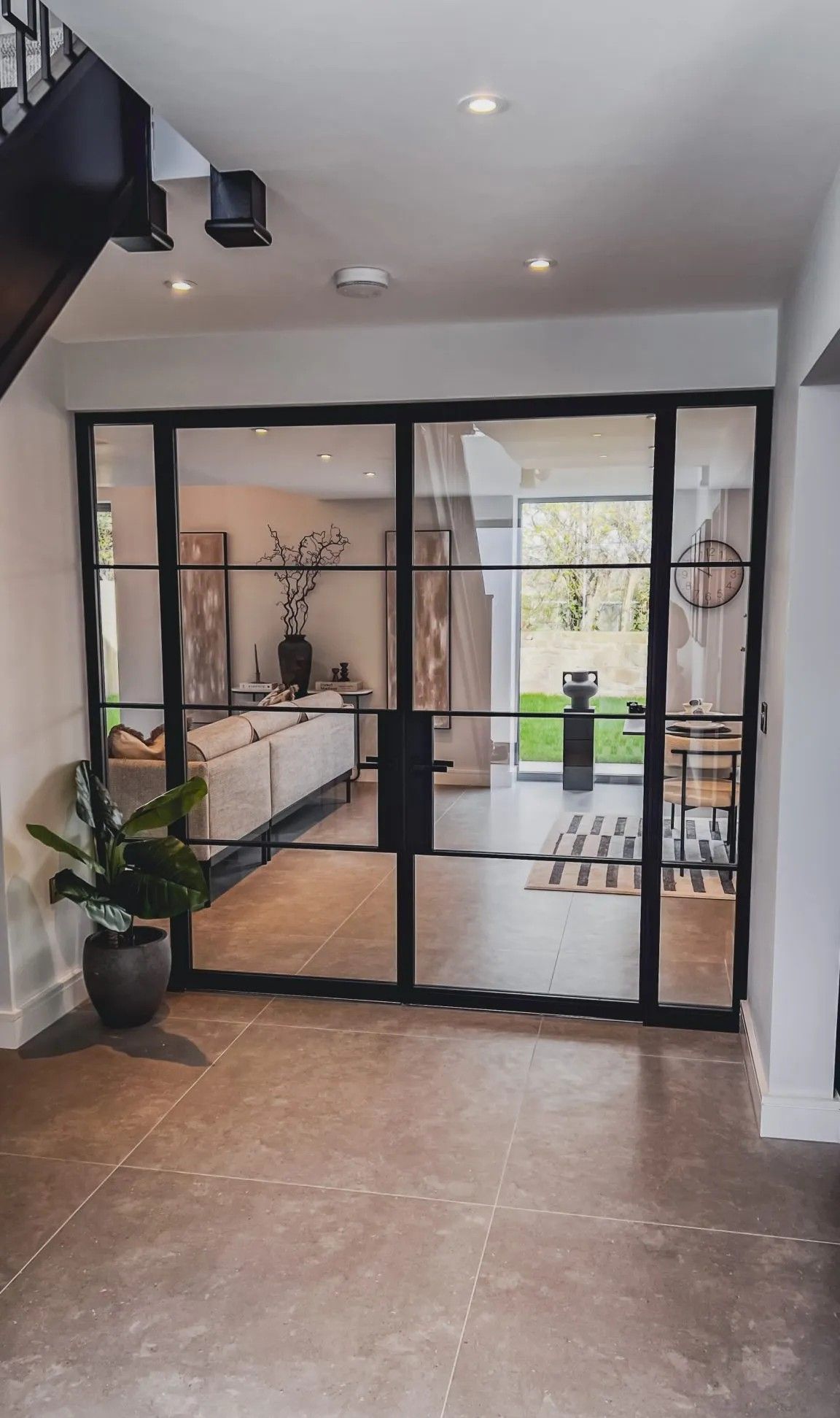 Welded Double Glass Doors & Glass Screens create an elegant Glass Partition that separates the Hallway from the Living Room