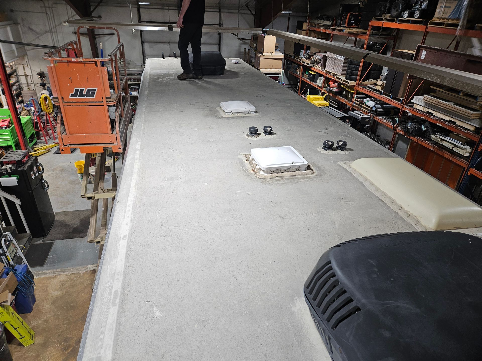 Workshop table covered in white felt, with tools and materials laid out in a cluttered workshop.