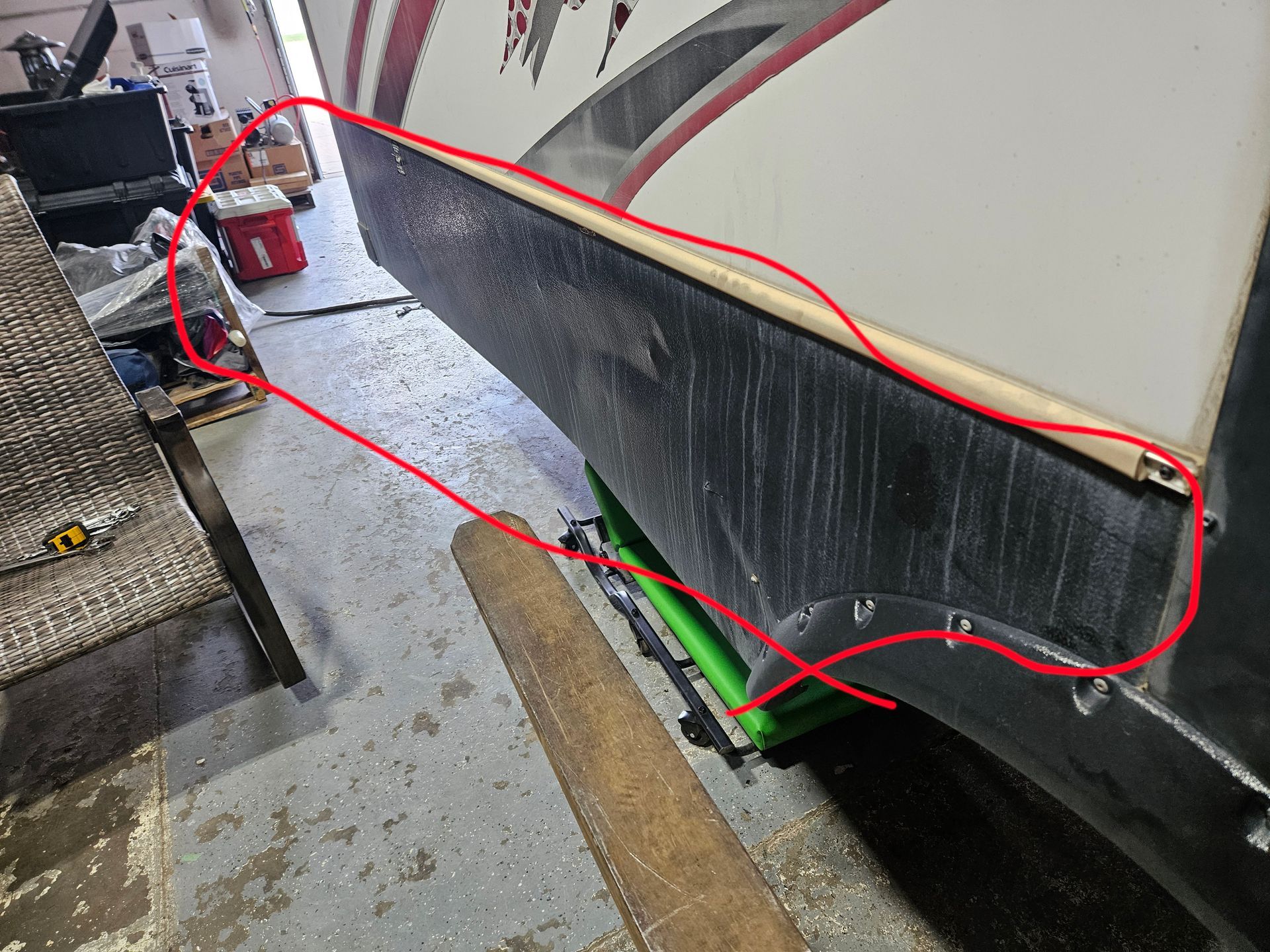 Red outline marking a boat’s lower side near the dock, with a green support under the hull.