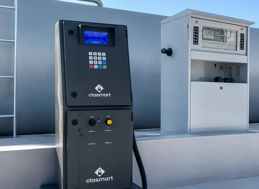 Estação de carregamento de veículos elétricos preta ao lado de um armário utilitário branco em um terraço ou estacionamento.