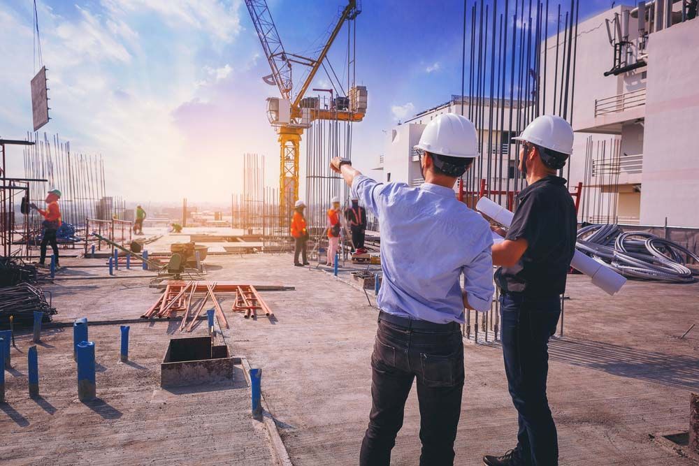 Two Engineers Discussing Site Construction — NBM Constructions