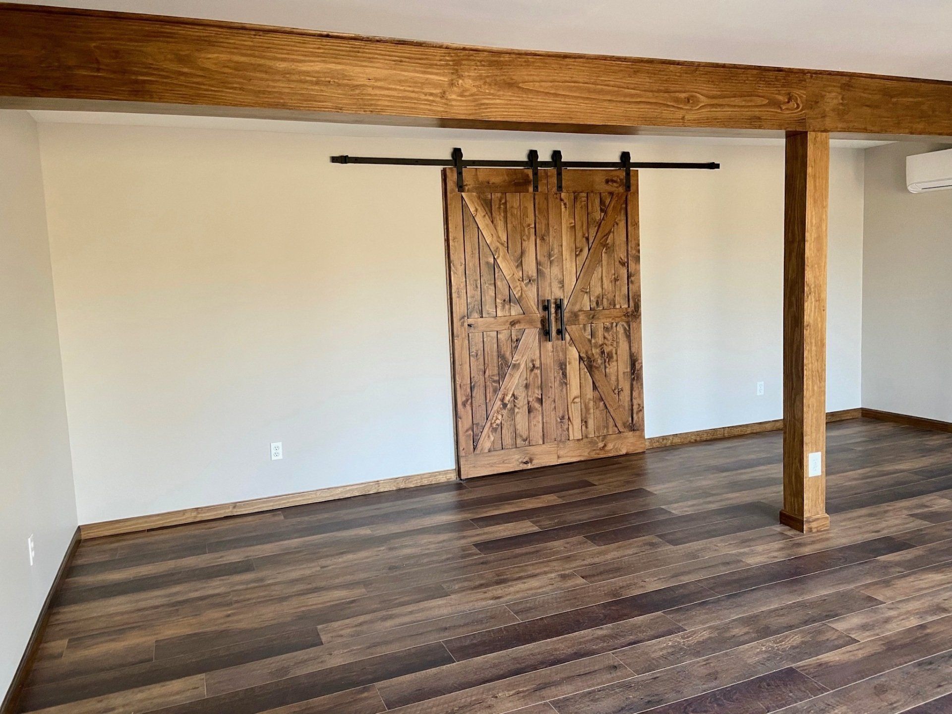Basement with Custom Door and Hard Wood Flooring