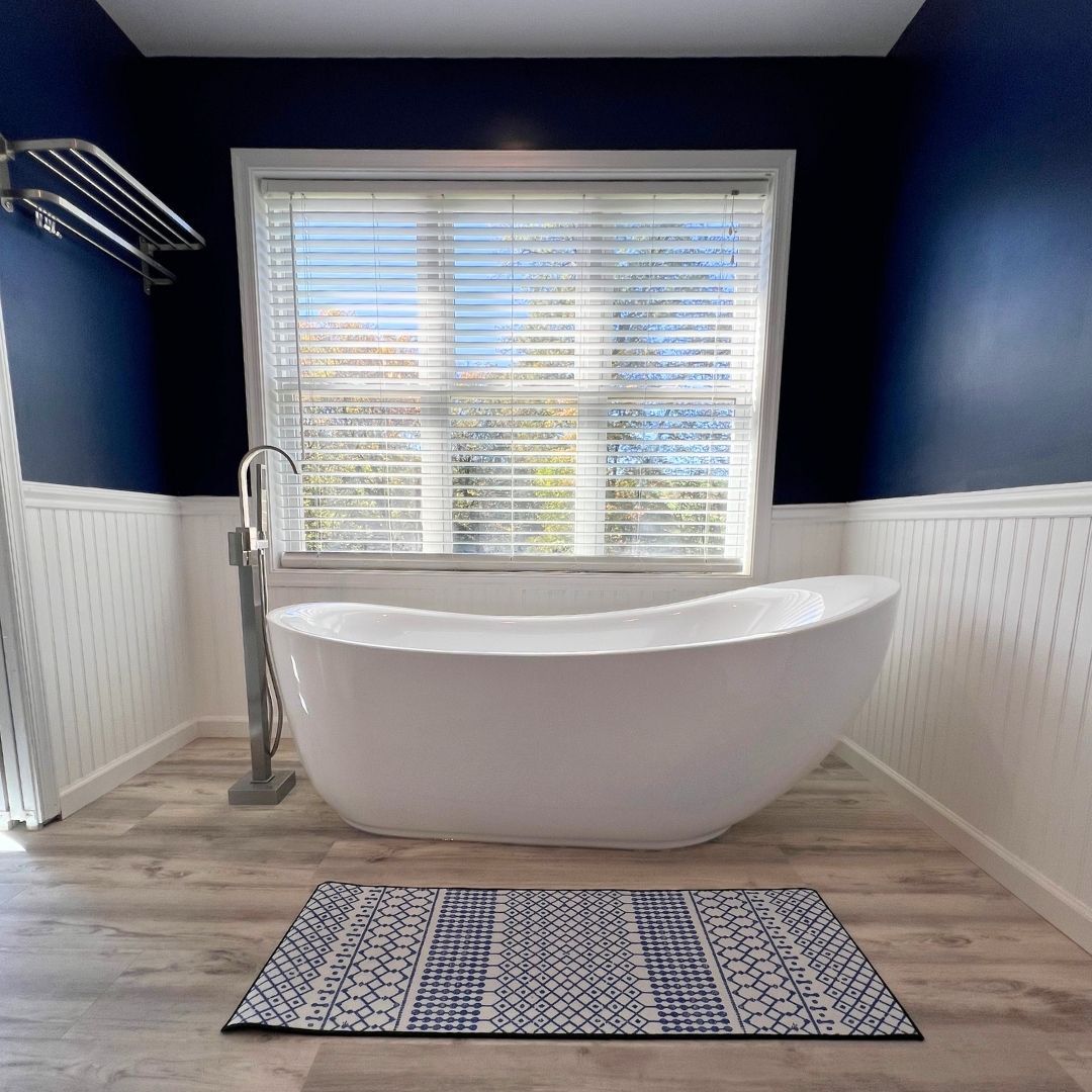 Beautiful Bathroom with Blue Walls, White Wainscoting, Window and Soaking Tub