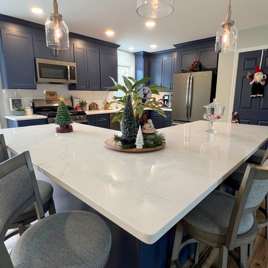 Kitchen Remodel with Blue Cabinets and White Marble Countertop.