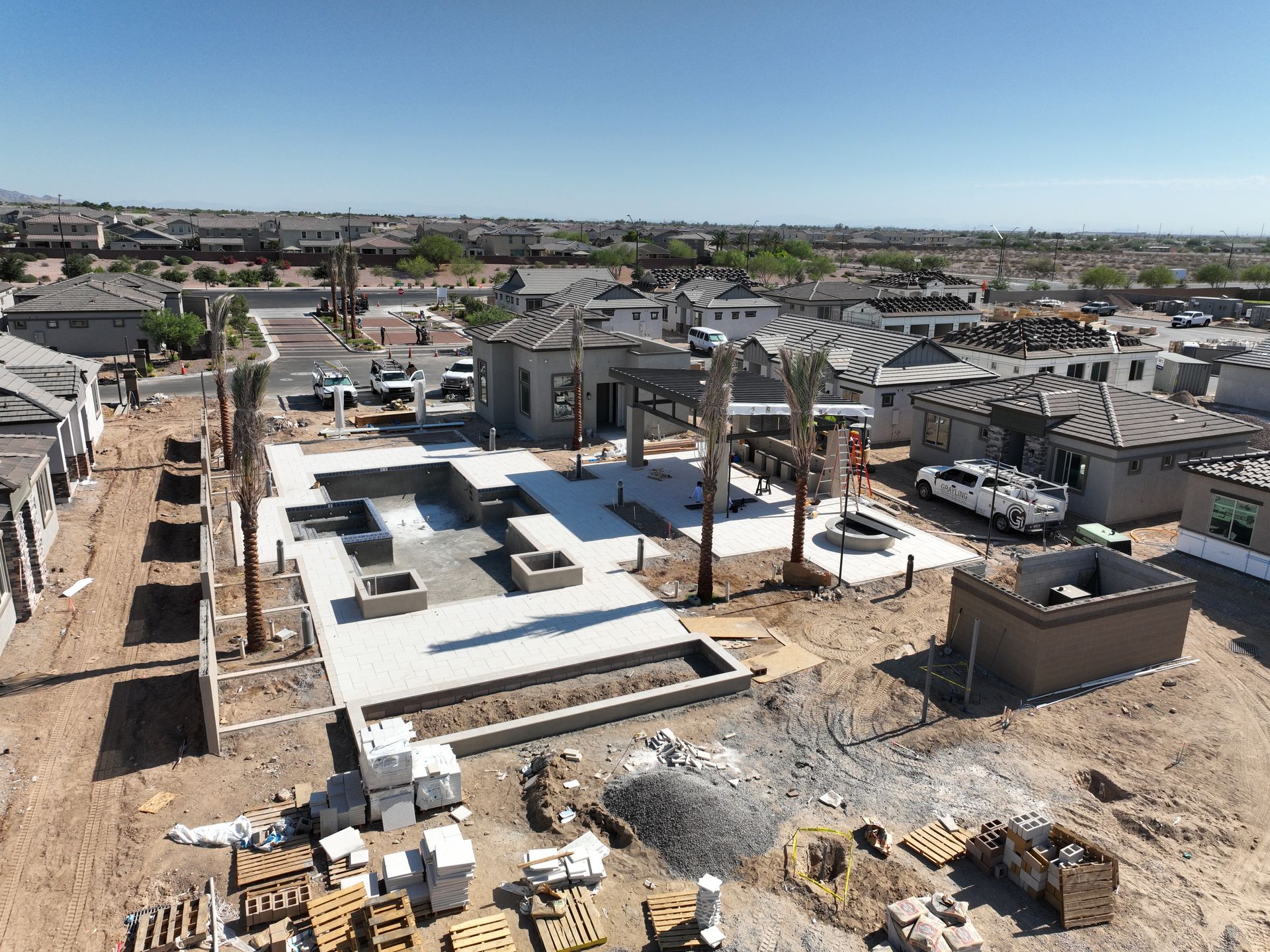 Residential neighborhood with houses, paved streets, and desert mountains in the distance