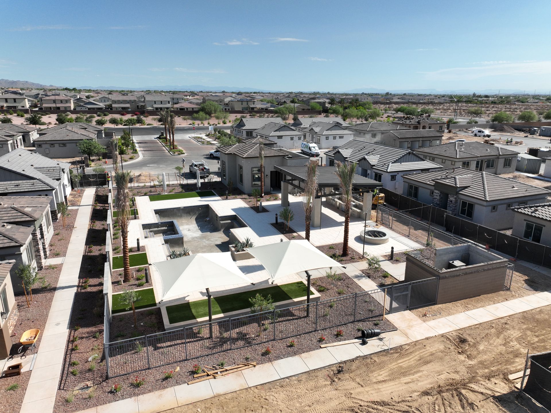 Aerial view of a modern neighborhood with rental homes, pool, and amenities