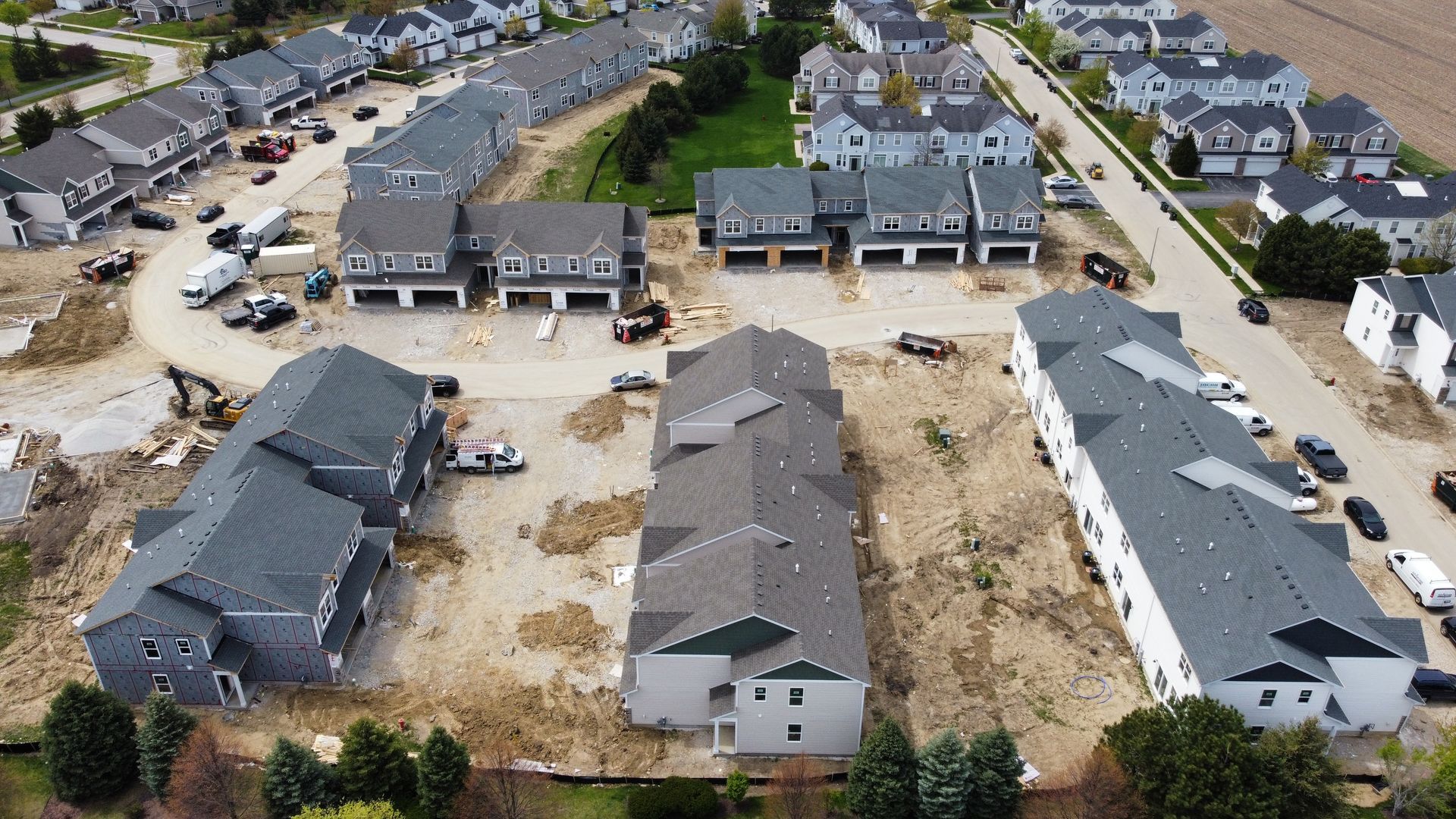 Aerial view of under-construction homes in a residential neighborhood.