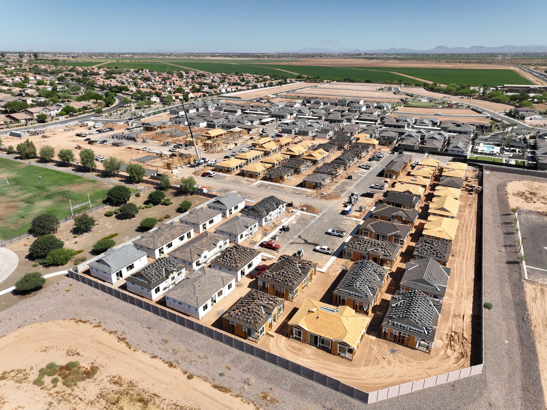 Aerial view of residential community construction with homes in various stages of completion