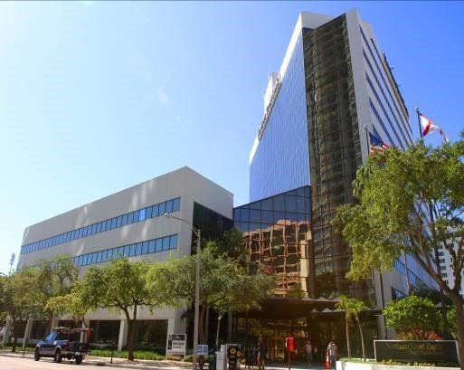 A large building with a lot of windows and trees in front of it
