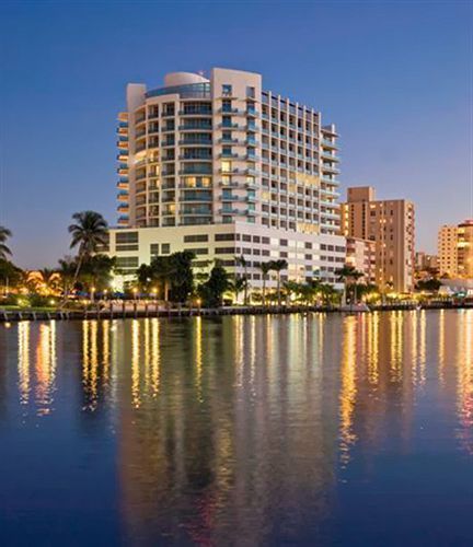 A large building is reflected in a body of water