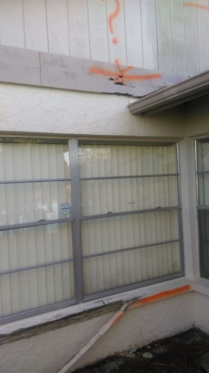 A window on the side of a building with graffiti on it.