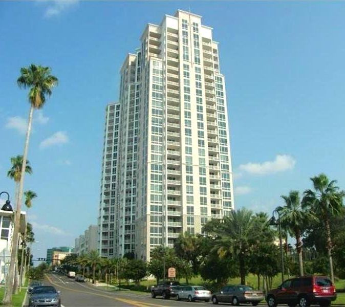 A tall building with cars parked in front of it