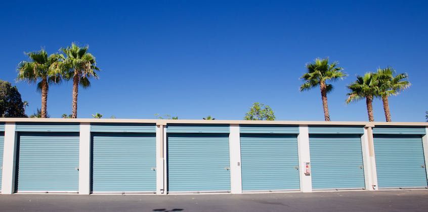 Row of blue roll-up storage unit doors
